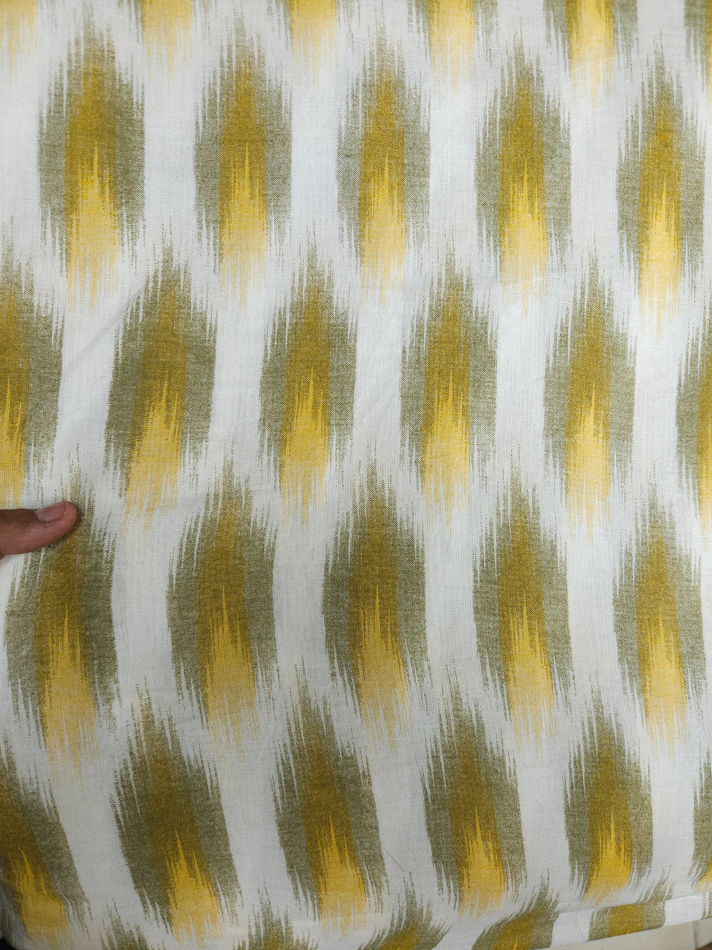 Close-up of fabric with a yellow and green pattern