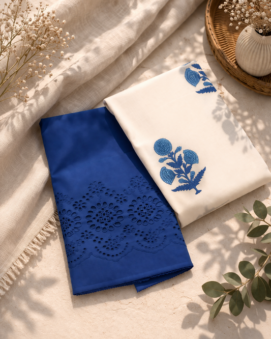 Blue fabric with intricate cut-out design and white fabric with blue floral embroidery on a light background.