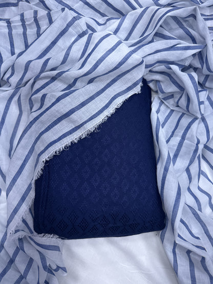 Blue and white patterned fabric with a textured navy square