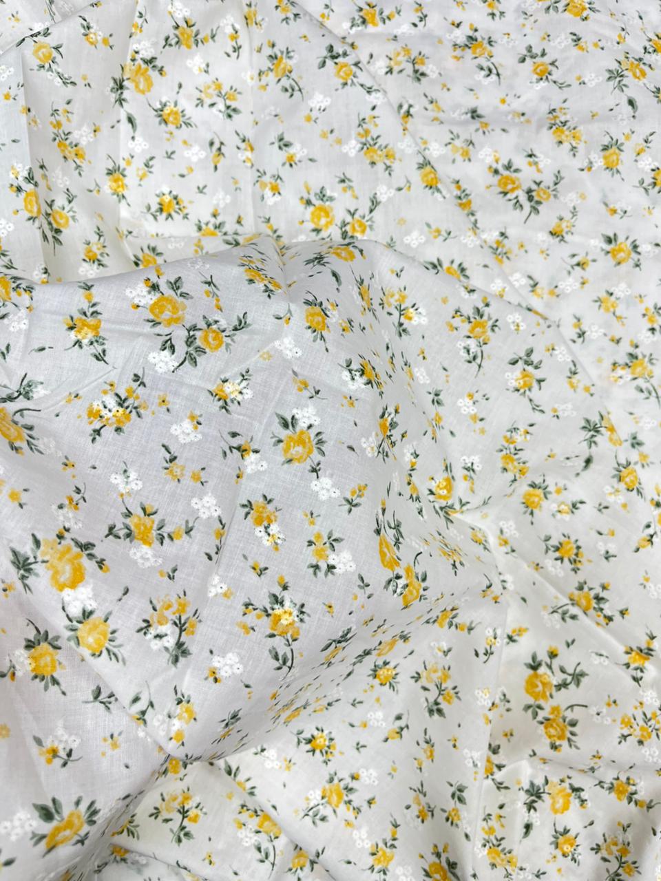 Floral patterned fabric with yellow flowers on a white background
