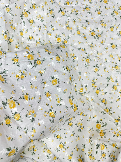 Floral patterned fabric with yellow flowers on a white background