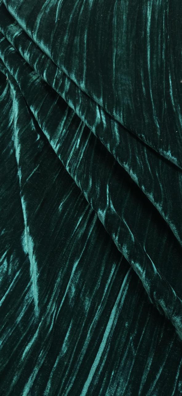 Close-up of teal velvet fabric with a textured pattern