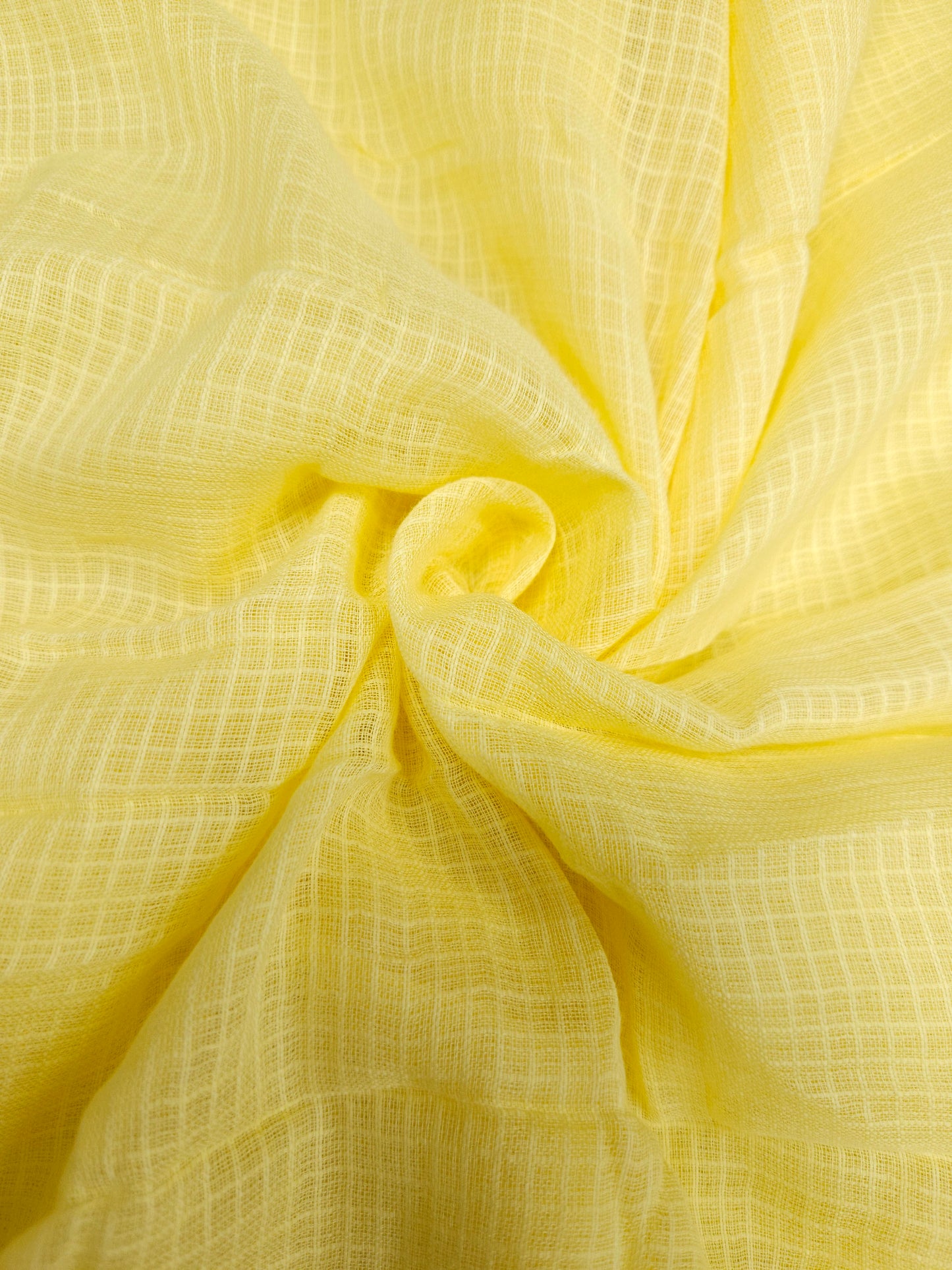 Close-up of yellow fabric with a textured pattern