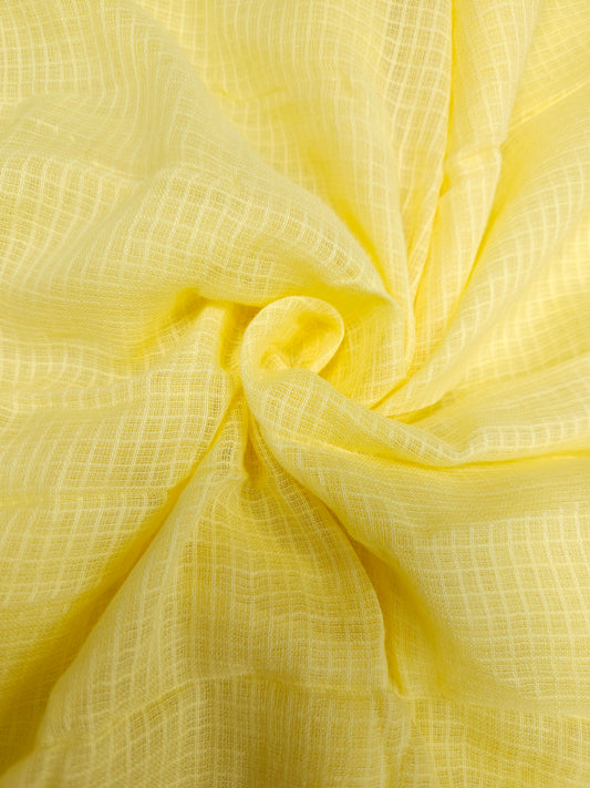 Close-up of yellow fabric with a textured pattern