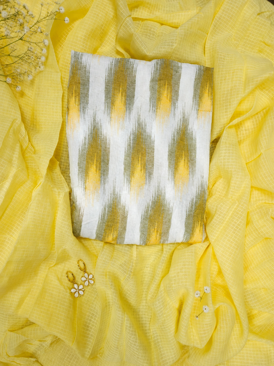 Yellow fabric with a silver and white patterned pouch and earrings on a yellow background